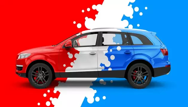 Half red, half blue SUV with a white splash design dividing the two colors, symbolizing a car wrap versus paint concept.